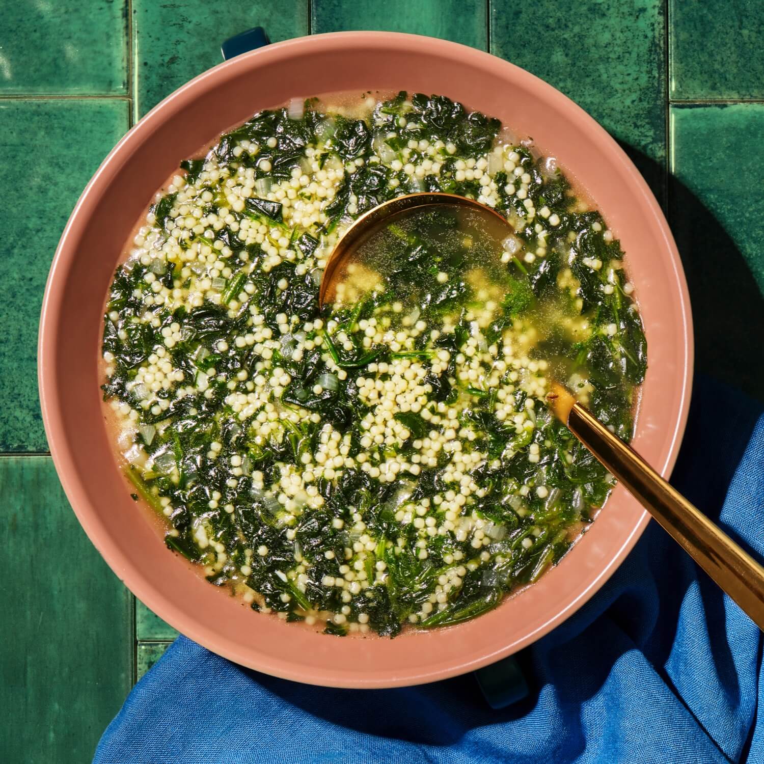 spinach soup with acini di pepe in serving bowl
