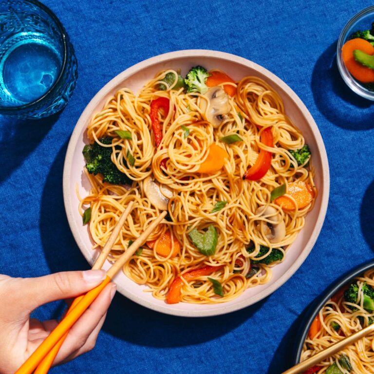 angel hair lo mein with broccoli and peppers in serving bowl