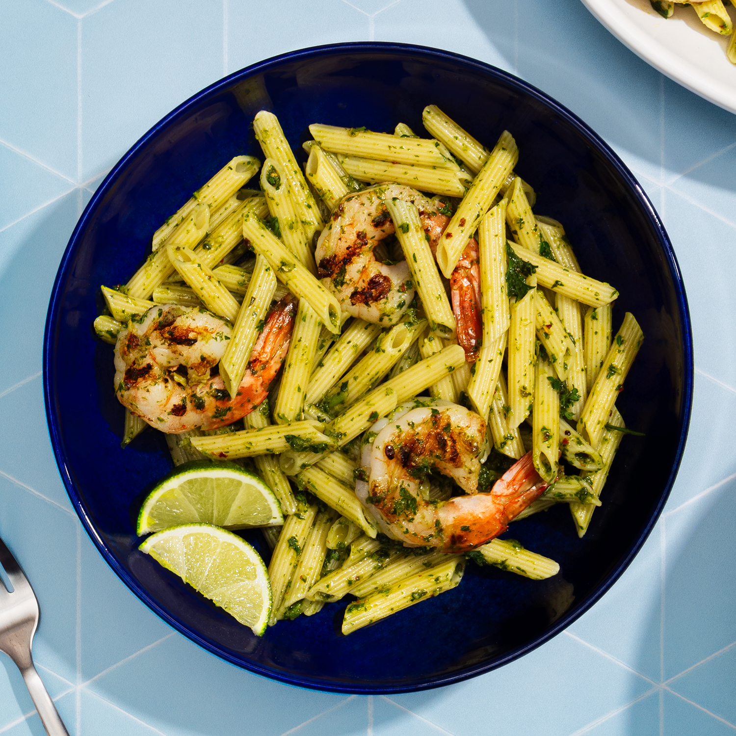 penne with shrimp in a chimichurri sauce on a plate