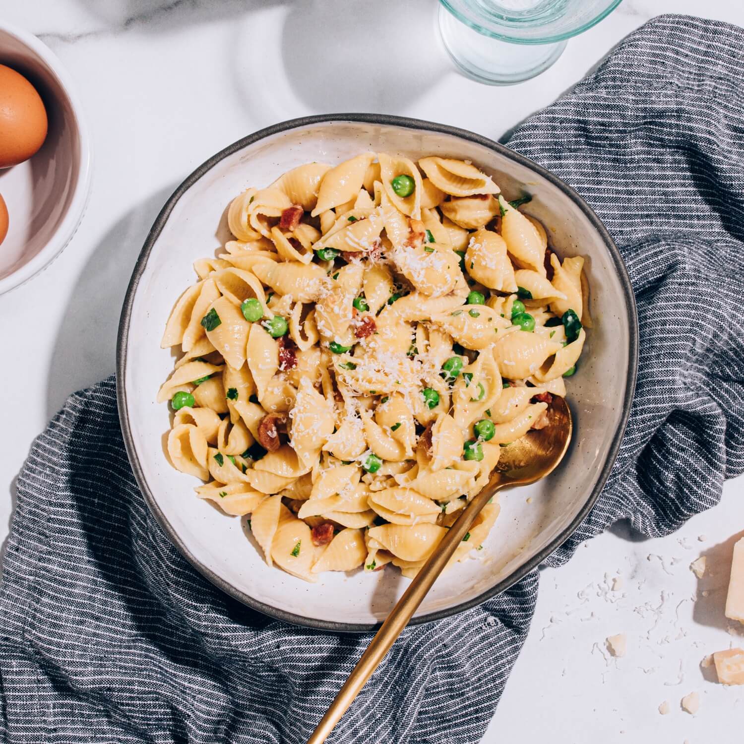 carbonara pasta salad with shells and peas in serving bowl