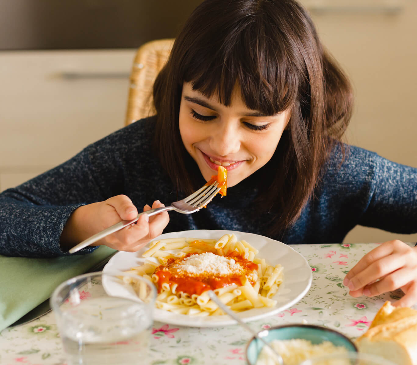 Smiling Child Eating Bite Of Pasta With Red Sauce