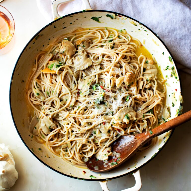 Spaghetti in skillet with clams in rich buttery sauce