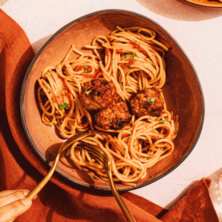 Thin Pasta Twirled In Dish With Meatballs And Tomato Sauce